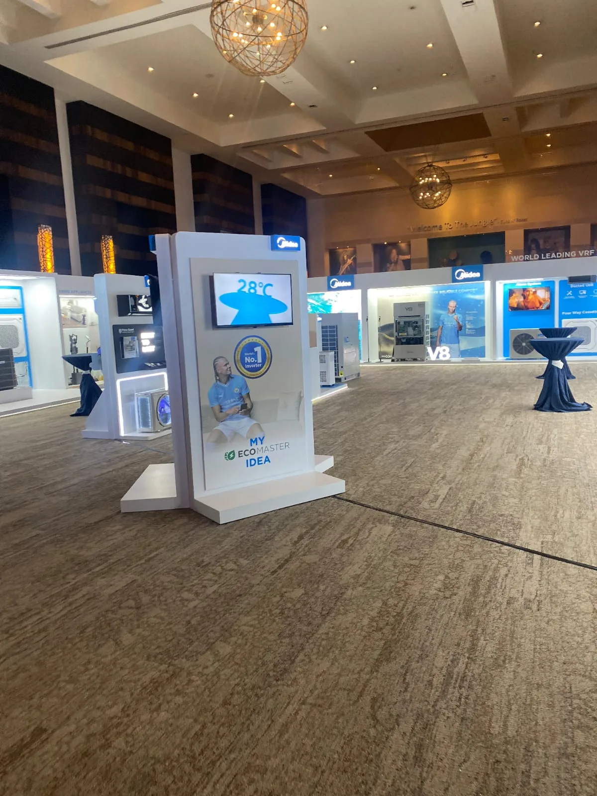 Exhibition stands installed inside a ballroom before a corporate event